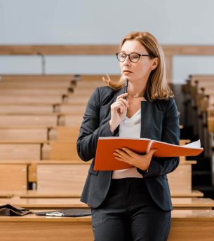 pensive-female-university-professor-holding-journa-2022-12-16-17-16-12-utc.jpg
